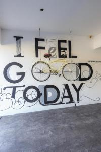 a yellow bike hanging on a wall with the words i feel sick day at TRYP by Wyndham Chetumal in Chetumal