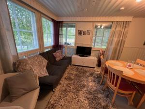 a living room with a couch and a table at Rantakatti Apartments in Punkaharju