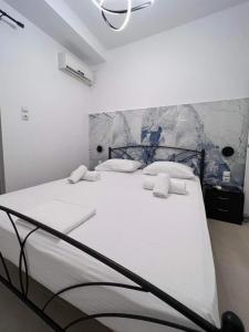 a bedroom with a large white bed with white pillows at Mano’s House Preveza 2 in Preveza