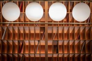 a row of white lights on a wooden shelf at Hotel Ercilla de Bilbao, Autograph Collection in Bilbao