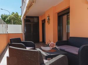 a patio with chairs and a couch and a table at Parrot’s House in Lloret de Mar