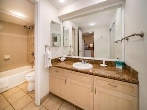 a bathroom with a sink and a toilet and a mirror at Kaanapali Maui at the Eldorado by OUTRIGGER in Lahaina