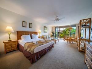 a bedroom with a large bed and a living room at Kaanapali Maui at the Eldorado by OUTRIGGER in Lahaina