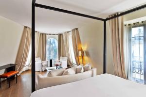 a bedroom with a bed and a living room at Le Metropolitan, Paris Tour Eiffel, a Tribute Portfolio Hotel in Paris