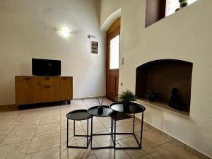 a living room with two chairs and a fireplace at Maisonette Nineta in Heraklio Town