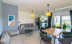 a living room with a couch and a table at Apartment Sweet Dream Manjiga in Nečujam