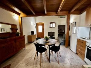 a kitchen with a table and chairs in a room at Maisonette Nineta in Heraklio
