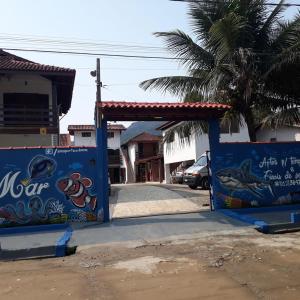 a gate to a parking lot with a car parked at Recanto Vizinho do Mar in Ubatuba