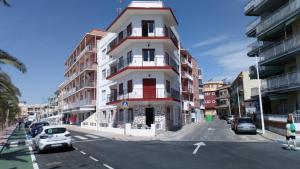 a tall building on a city street with cars parked at casa frente al mar in San Pedro del Pinatar