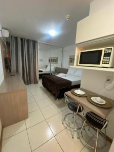 a hotel room with a bed and a table at Flat 309 Life beira lago in Brasilia