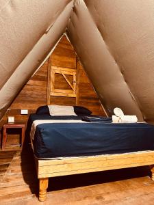 a bedroom with a bed in a tent at La Aldea Holbox Cabañas y Camping in Holbox Island