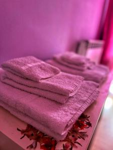 a pile of pink towels sitting on a table at La Casa dei Panorami in Castelsaraceno