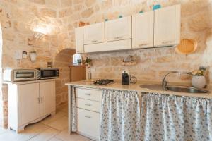 A kitchen or kitchenette at Trullo Milù with Pool