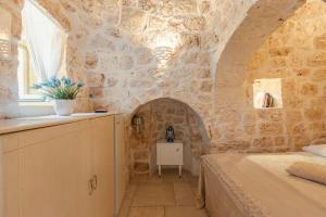 A bed or beds in a room at Trullo Milù with Pool