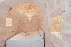 A bed or beds in a room at Trullo Milù with Pool