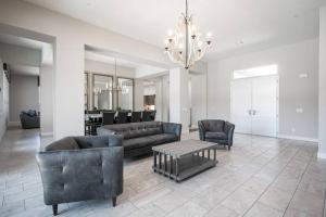 a living room with couches and a chandelier at Luxury home close to everything in Las Vegas