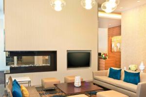 a living room with a couch and a tv at Residence Inn by Marriott Boston Back Bay/Fenway in Boston