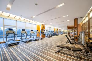 a gym with rows of treadmills and benches at Four Points by Sheraton Chengdu, Pujiang Resort in Pujiang
