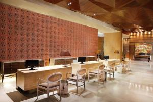 a lobby with desks and chairs and a red wall at Four Points by Sheraton Bali, Seminyak in Seminyak