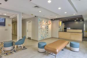 a waiting room with a table and chairs and a wall at TownePlace Suites Tallahassee North/Capital Circle in Tallahassee