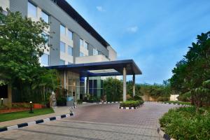 a building with a brick walkway in front of it at Fairfield by Marriott Chennai Mahindra World City in Chengalpattu