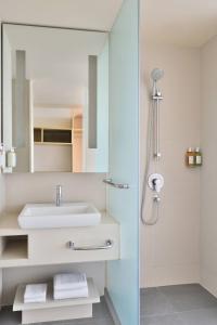a bathroom with a sink and a mirror at Fairfield by Marriott Chennai Mahindra World City in Chengalpattu