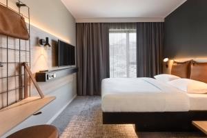 Letto o letti in una camera di Moxy Dresden Neustadt