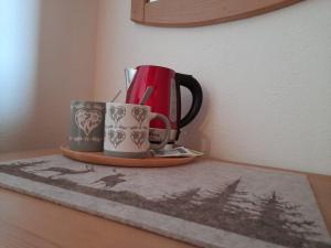 two coffee cups are sitting on a table at Bed & Breakfast La Crotta in Pont-Saint-Martin