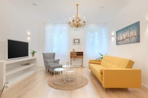 a living room with a couch and a tv at Calafati Apartment with free private parking in Rijeka