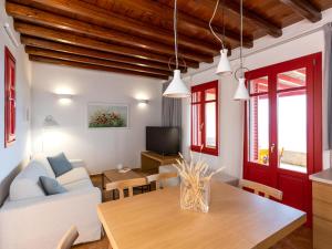 a living room with a white couch and a table at Bella Resorts Andros in Andros