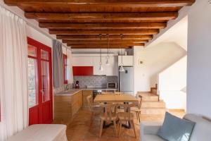 a kitchen and dining room with a table and chairs at Bella Resorts Andros in Andros