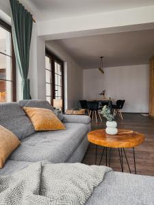 a living room with a couch and a table at Pensiunea Oacheș in Sălaşu de Sus