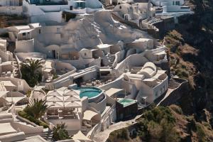 an aerial view of a city with white buildings at Mystique, a Luxury Collection Hotel, Santorini in Oia