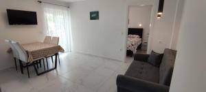 a living room with a couch and a table at Apartments INBOX in Kostrena