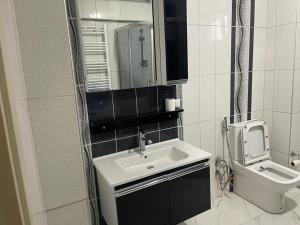 a bathroom with a sink and a toilet at Yalova Apartments in Yalova
