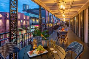 a balcony of a restaurant with tables and chairs at Four Points by Sheraton French Quarter in New Orleans