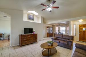 a living room with a couch and a flat screen tv at Convenient Las Cruces Home with Patio and Grill! in Las Cruces