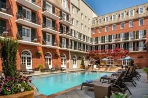 a courtyard with a swimming pool in front of a building at Four Points by Sheraton French Quarter in New Orleans