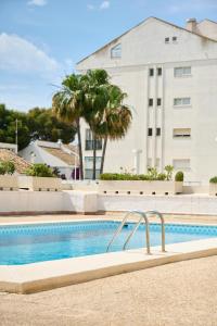 a swimming pool in front of a building at Altea Piscina Playa in Altea