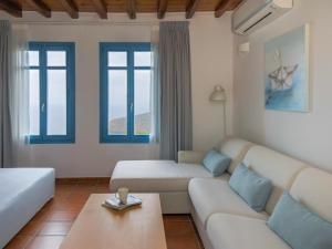 a living room with a couch and a coffee table at Bella Resorts Andros in Andros