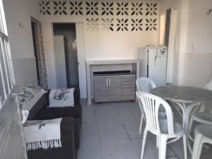 a living room with a couch and a table at Ap 04-A 50 Metros da Praia Flats Mobiliados para 2 Pessoas in Paulista