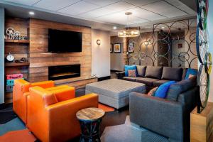 a living room with furniture and a flat screen tv at Four Points by Sheraton Barrie in Barrie