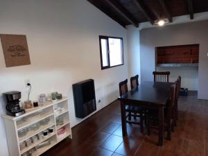 a kitchen and dining room with a table and chairs at Casagrande in Esquel