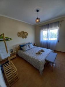 a bedroom with a bed with two shoes on it at Casa Madeira in Burgau