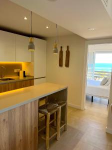 a kitchen with a counter and a bed in a room at Apartamentos Nogal in Aguadulce