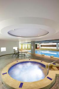 a swimming pool in a building with a swimming pool at Sheraton Bogotá Hotel in Bogotá