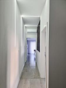 a hallway with white walls and a table in a room at Adria Mare in Crikvenica