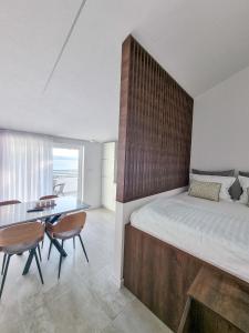 a bedroom with a large bed with a wooden headboard at Adria Mare in Crikvenica