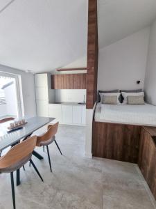 a bedroom with a bed and a table and chairs at Adria Mare in Crikvenica