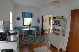 a kitchen with a table and a dining room at Innisfreedom cabin in Sligo